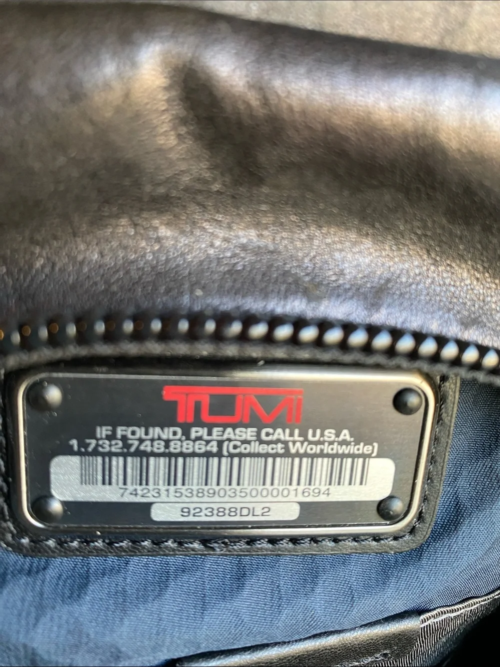Tumi Black Leather Roll-Top Backpack with Front Pockets